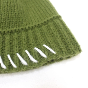 Green chunky knit bucket hat for women with white hand-stitched decorative edge detail