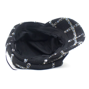 Vintage black tweed newsboy cap with plaid patterns and warm wool finish for women