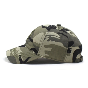 Detail view of camouflage baseball cap showing frayed edge stitching and cotton fabric