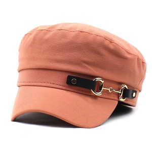 Detailed side view of cotton navy hat with leather strap and golden horsebit buckle