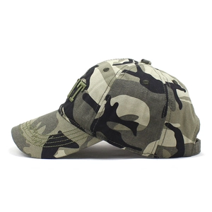 Close-up of camouflage baseball cap featuring green 3D embroidered letter H and stitched brim
