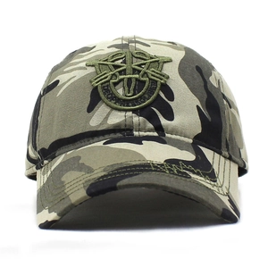 Macro shot of embroidered De Oppresso Liber logo on military camouflage baseball cap
