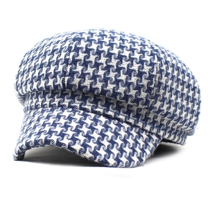 Detailed view of winter houndstooth baker boy hat with warm wool blend fabric texture