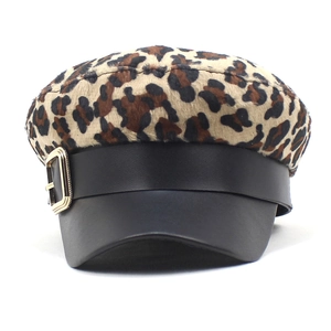 Chic leopard print baker boy hat featuring a black faux leather brim and gold metal buckle