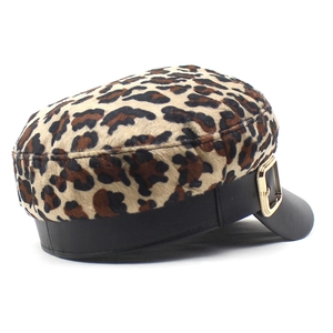 Detail view of leopard print faux fur baker boy hat with leather strap and gold buckle