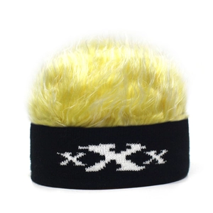 Detail showing bright yellow wig texture and black knit beanie with XXX pattern