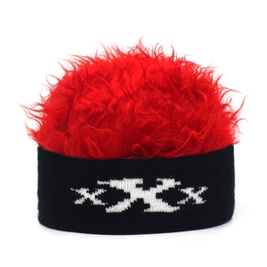 Close-up of novelty knit hat with fluffy red wig hair and white XXX embroidery detail