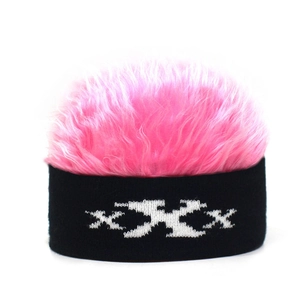Detail of pink faux fur top and black knit texture on XXX patterned beanie hat
