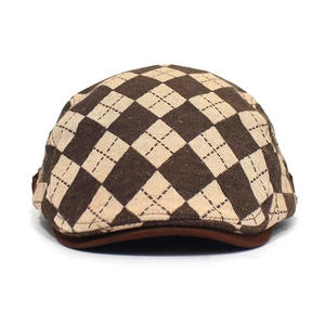 Close-up of brown argyle knit texture and structured brim on this vintage flat cap