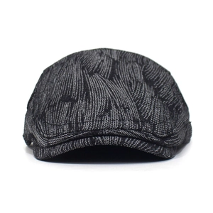 Detailed view of the dark grey textured cotton jacquard fabric on the beret hat