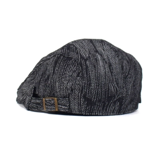 Close-up of retro denim beret with adjustable bronze metal buckle and woven texture