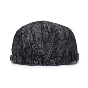 Detail of the metal adjustment buckle on the textured grey denim cotton beret hat
