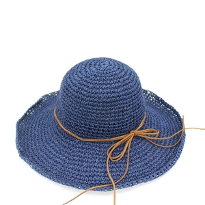 Navy blue raffia sun hat with wide brim and brown string bow for beach vacations