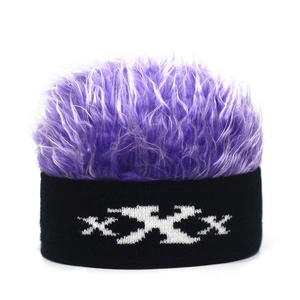 Detail view of funny knitted beanie with purple faux hair and XXX woven pattern