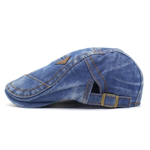 Detail of vintage blue denim beret with orange contrast stitching and adjustable buckle
