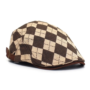 Detail of vintage checkered flat cap showing side adjustable strap and bronze buckle