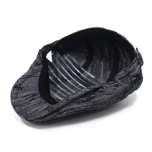 Detailed view of dark grey textured denim beret with metal side buckle and inner lining