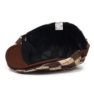 Detailed view of checkered beret interior showing 35% cotton 65% polyester fabric label