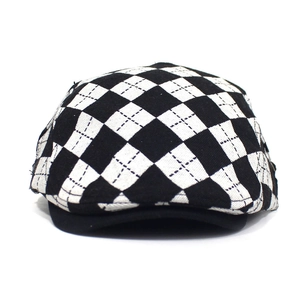 Close-up of vintage black and white rhombic pattern on a classic flat cap for women
