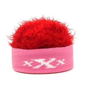 Macro detail of pink knit headband with white XXX pattern and fluffy red faux fur wig