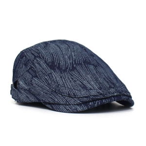 Detailed close-up of dark blue jacquard denim beret showing woven texture and stitch