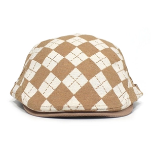 Macro detail of the classic argyle pattern weaving on the retro brown flat cap