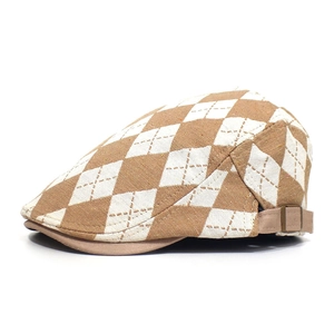 Detail view of brown diamond pattern flat cap with side metal buckle adjustment