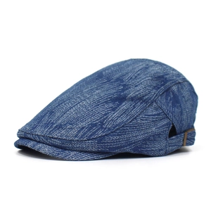 Detailed macro view of denim flat cap showing metal adjustment buckle and striped texture