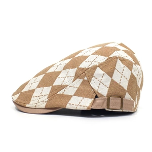 Side view of retro diamond pattern beret with adjustable bronze metal buckle and strap