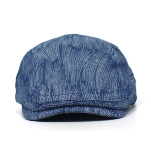 Close-up of dark blue denim beret featuring wavy distressed texture and vintage wash
