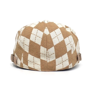 Detailed back view of a diamond lattice newsboy cap with adjustable metal buckles