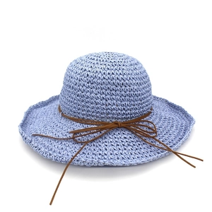 Light blue raffia straw sun hat with wide brim and brown bow for beach vacation sun protection
