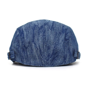 Detailed close-up of blue denim texture and metal buckle on this vintage flat cap
