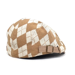 Detail of adjustable metal buckle and brown diamond pattern on vintage beret cap