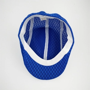 Detailed interior view of a navy mesh newsboy cap showing the breathable texture and sweatband