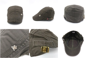 Detail view of cotton flat cap with metal lion crest and adjustable bronze buckle