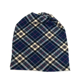 Detail of classic navy and white plaid knit beanie with soft warm fabric texture