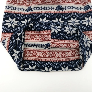Women's knit Fair Isle snowflake pattern beanie hat with navy and red winter motifs