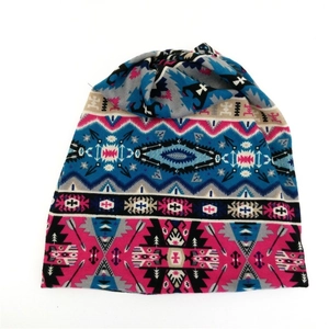 Detail showing the intricate ethnic geometric knit pattern on a multi-use beanie scarf