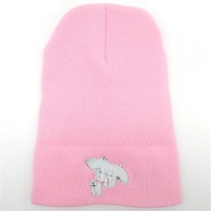 Close-up of pink knit beanie featuring detailed cartoon character embroidery and ribbed texture