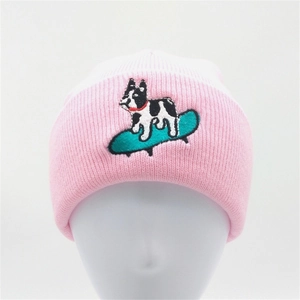 Knit beanie hat in pink and white with a dog on a skateboard embroidery design