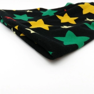 Black knit beanie with colorful star patterns shown in a close-up diagonal view