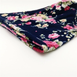Thick warm winter beanie for women with pink floral print on dark navy knit fabric