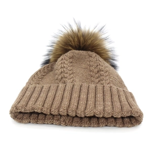 Women's cable knit beanie in dark brown with a large fluffy raccoon fur pompom detail