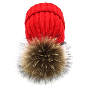 Bright red knit beanie with fluffy faux fur pompom for women and children winter warmth