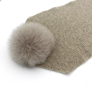 Winter rib-knit warm beanie hat with a large fluffy faux fox fur pompom in khaki beige