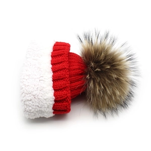 Winter knit hat in red with white plush brim and fluffy brown faux fur pom pom
