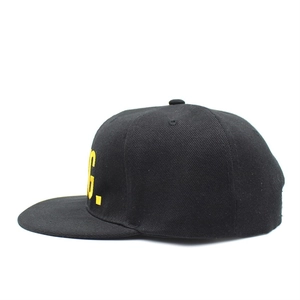 Detail view of the black cotton twill snapback cap featuring yellow letter G embroidery
