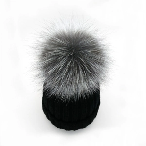 Thick black ribbed knit beanie with a fluffy grey silver fox fur pompom for winter