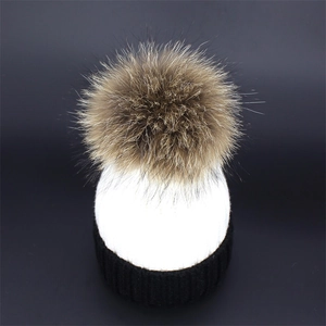 Chic two-tone knit beanie with large fur pompom in black and white winter style